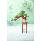 Kirschblüte Bonsai aus Holz mit rosa und hellrosa Blüten und grünen Blättern