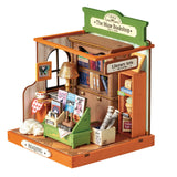 The Muse Bookshop Miniaturhaus mit Fassade und Schriftzug Book a Coffee