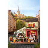 Aromatic Coffee Cart Miniaturhaus: grünes Lastenfahrrad mit Speichenrädern und großer Kiste