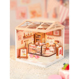 Miniaturhaus Bäckerei Tasty Cake Shop: Küchlein auf hoher Präsentationsplatte